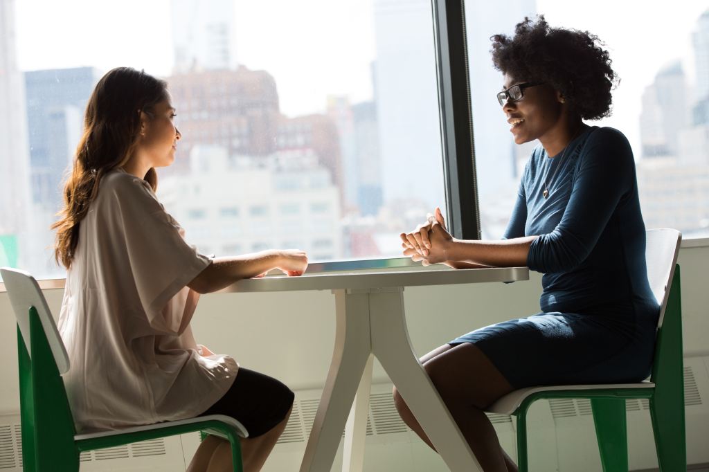 Two women meeting at a table. Photo by Christina @wocintechchat.com courtesy of Unsplash. 
  